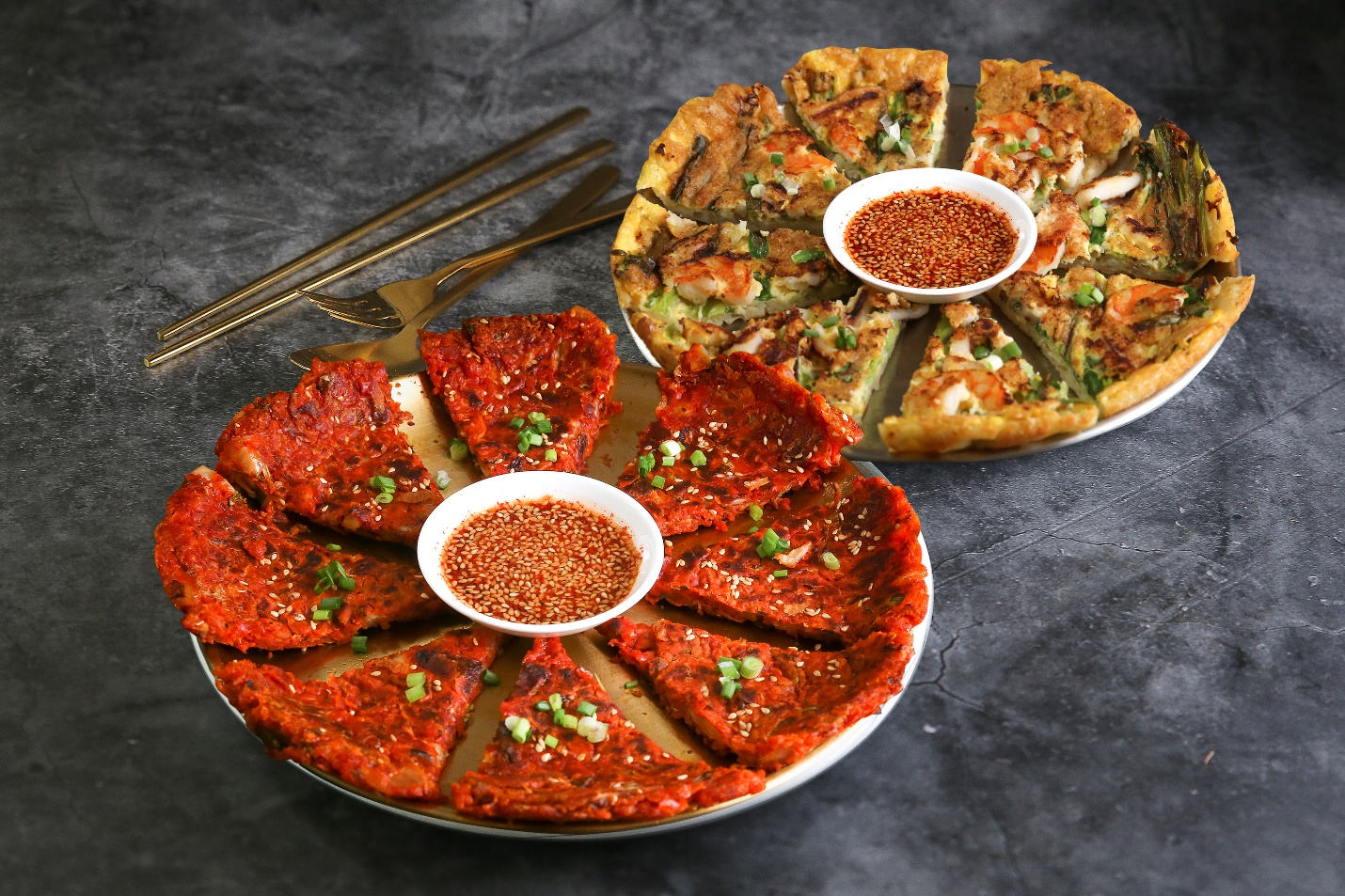 A group of pizzas with sauces on them

Description automatically generated